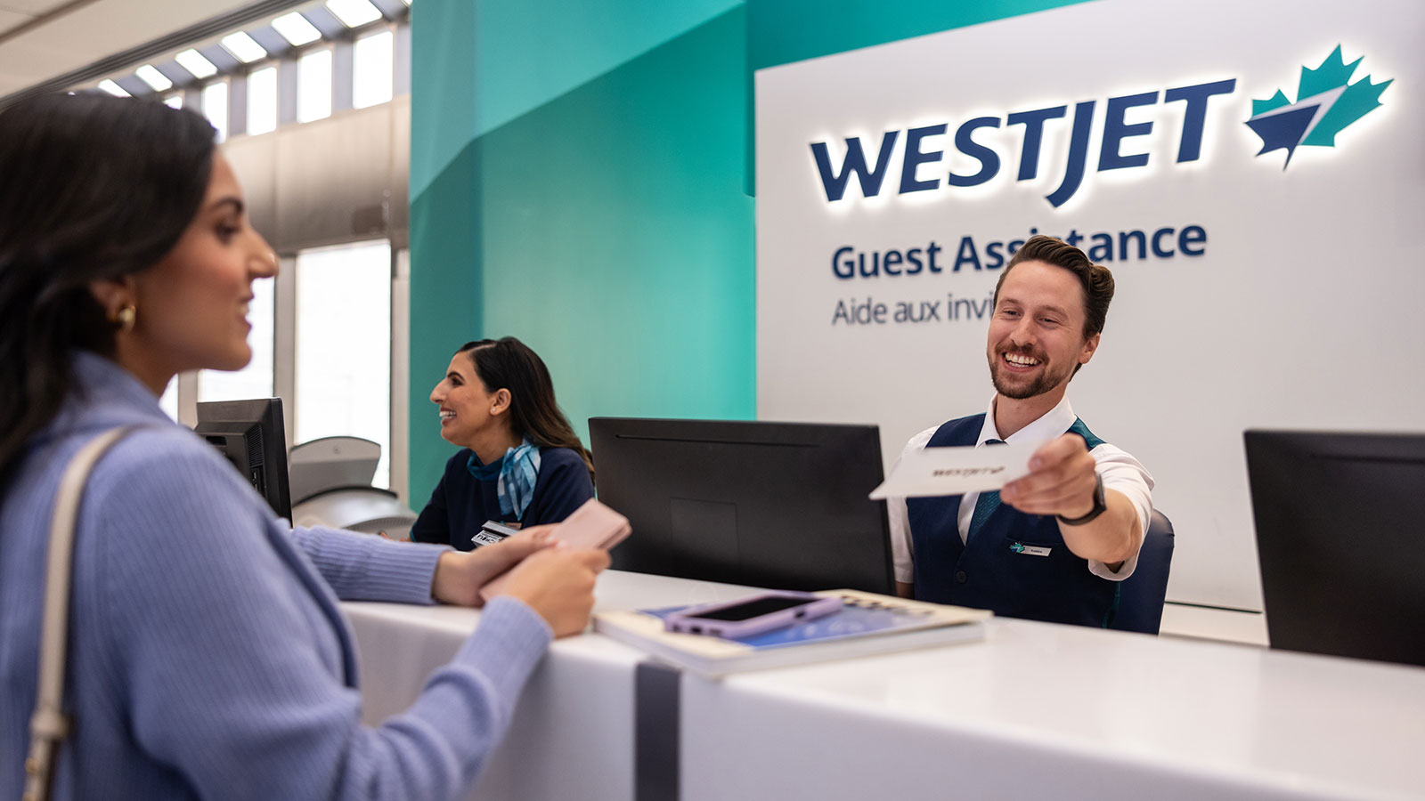 Guest talking with a WestJet agent.