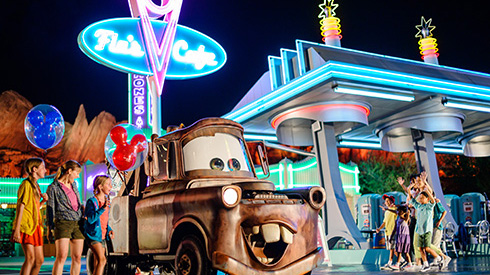 Three guests outside at Cars Land, Disneyland Resort in California