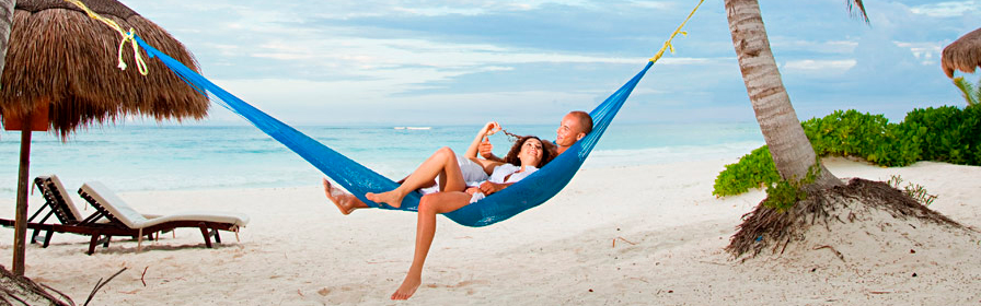 Couple relaxing in a hammock on a beach