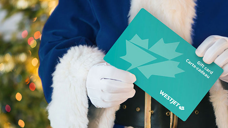 Santa Claus azul sosteniendo una tarjeta de regalo de WestJet 