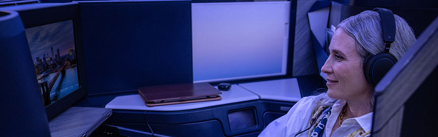 Woman in business class with headphones 