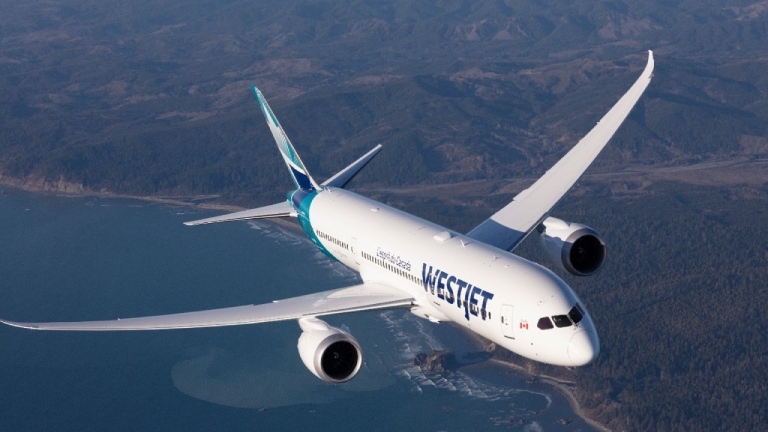 WestJet 787-9 Dreamliner flying over the coast