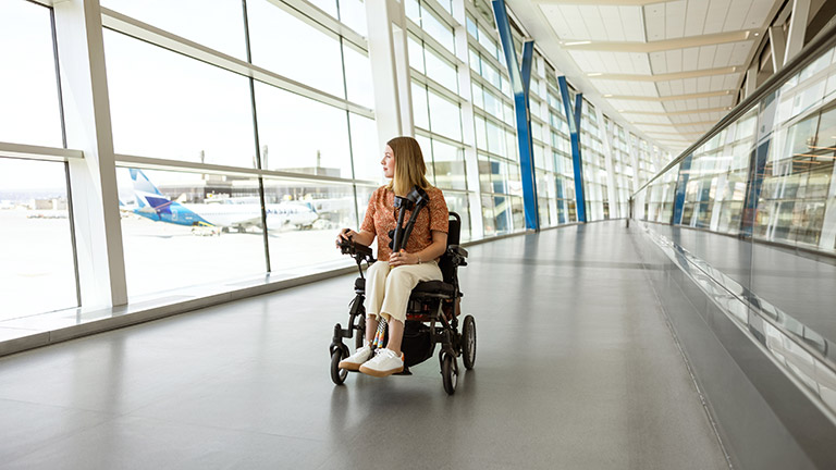 Woman in wheelchair exploring the boarding lounge