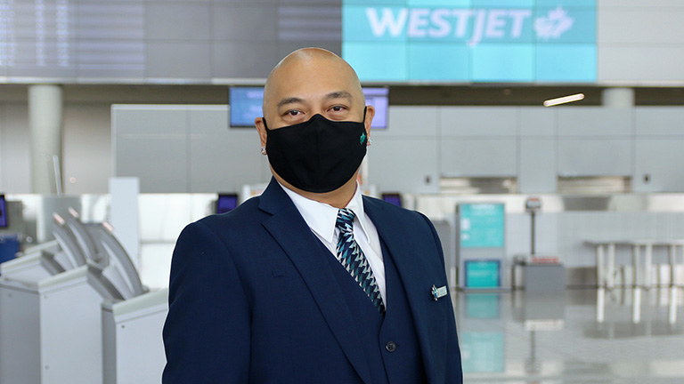 WestJet employee wearing mask in airport