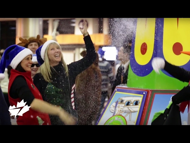 People dancing with blue Santa hats