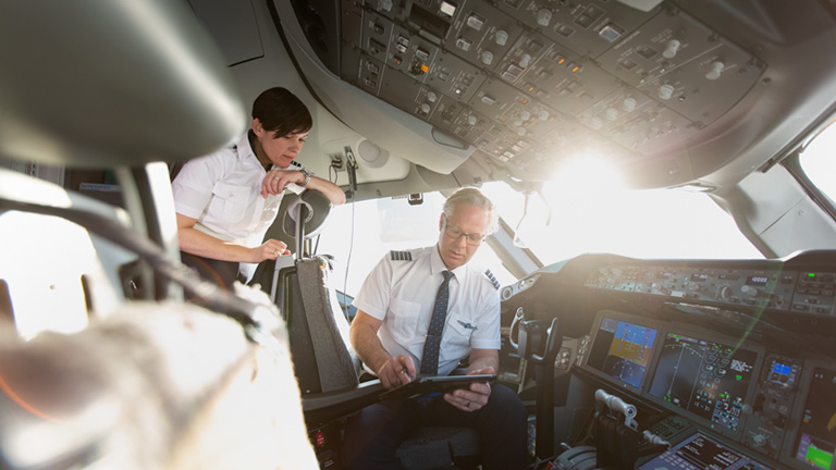 Female and male pilots in WestJet cockpit