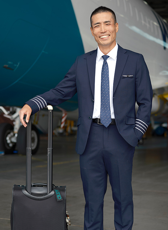 WestJet pilot with a travel suitcase
