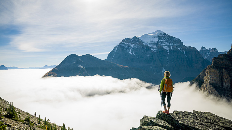 Hiker standing on top of a mountain in Alberta