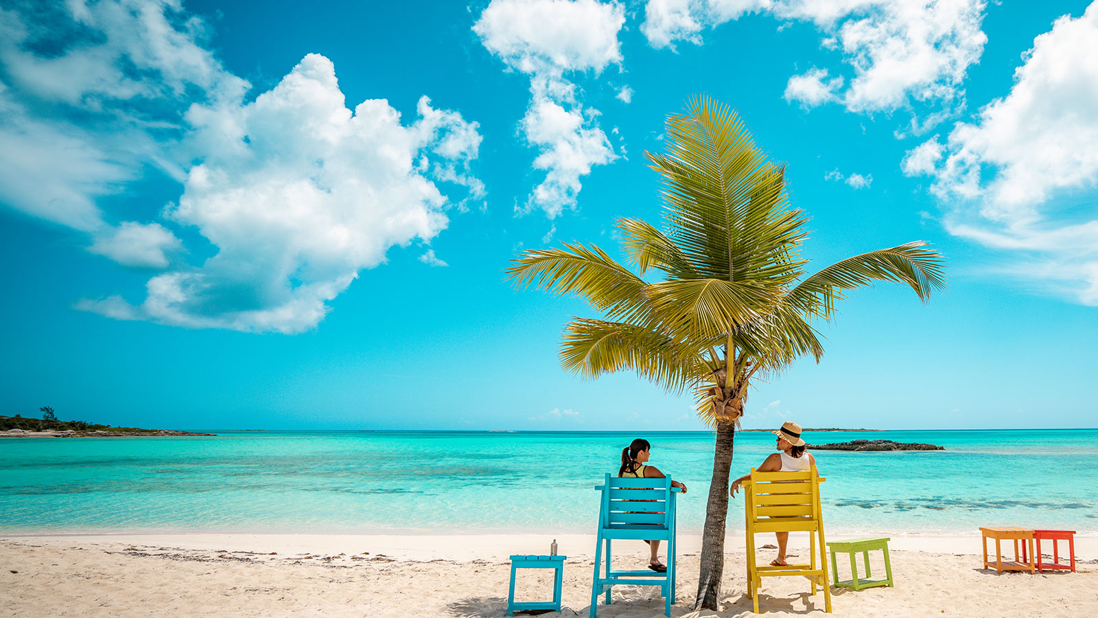 Two people relaxing in beach chairs 
