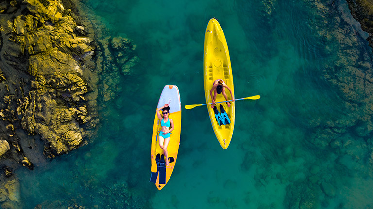 Couple kayaking along a river