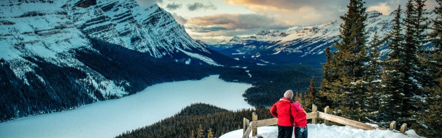Mother and daughter viewing mountains in winter