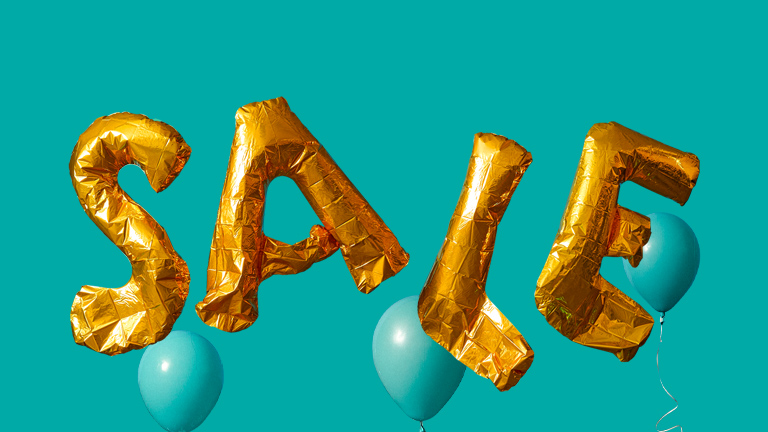 Gold balloons spelling out "SALE"