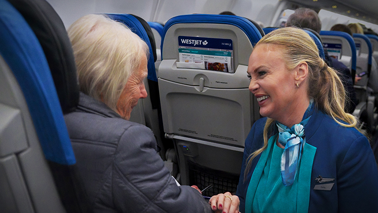 WestJet agent speaking to a guest