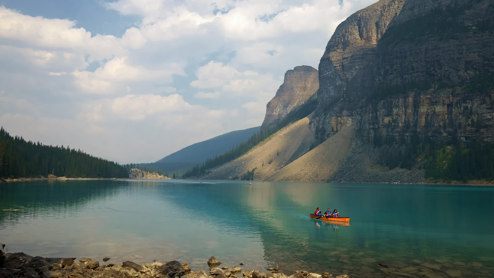 People kayaking on a mountain lake