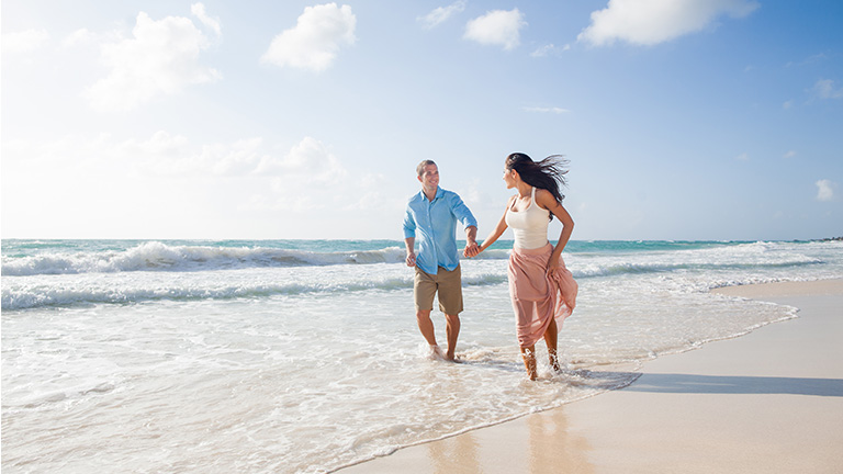 A couple walking along a beach