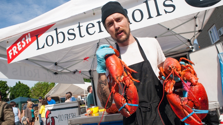 Man holding lobsters at Boyce farmers market