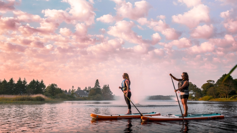 Two women on stand-up paddle boards