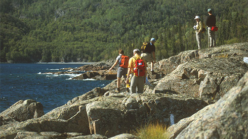 Hikers on Lake Superior shore rocks