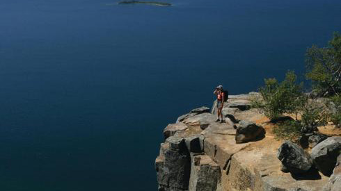 Hiker looking out over Lake Superior from cliff at Sleeping Giant provincial park