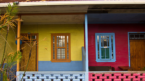 The outside of two San Jose homes that are painted bright colours