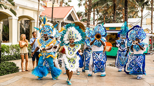 Festive dancers at Junkanoo wearing blue outfits
