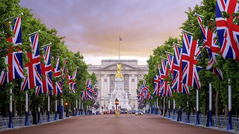 The Union Jack Flags and trees lining the path to Buckingham Palace.