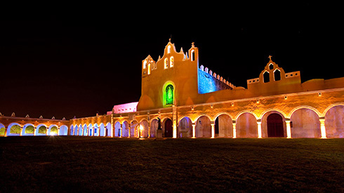 A building in Merida at night time with lights on