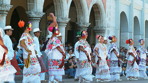 Traditional women dancing in dresses downtown Merida