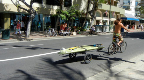 Towing a surfboard, Honolulu, Oahu