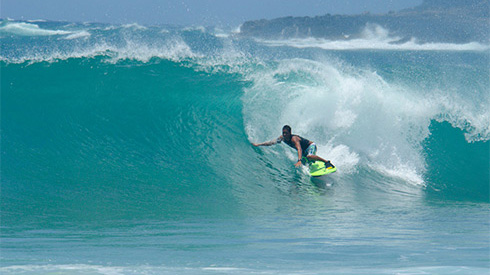 Surfer riding a wave, Kauai