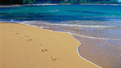 Footprints in sand, Makua Beach, Kauai