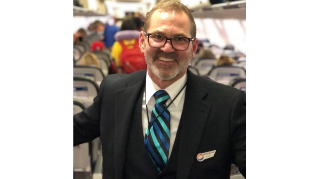 Robert Antoniuk, WestJet Executive Vice-President and Chief Operating Officer, operating his first flight as a WestJet-qualified cabin crew member.