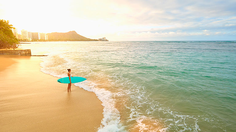 Surfer on the beach in Honolulu