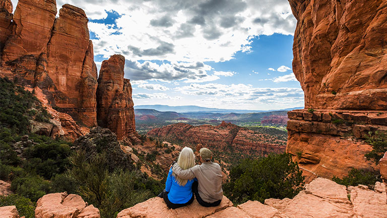 Couple sitting in the desert admiring the view