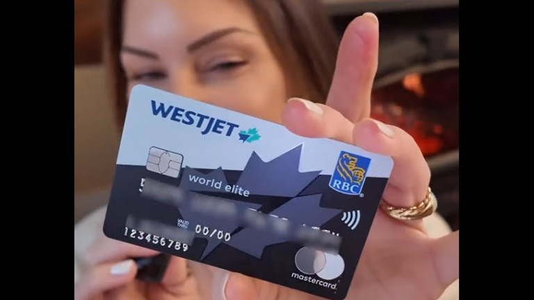 Woman holding WestJet RBC World Elite Mastercard