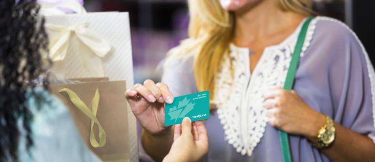 Woman holding a gift card 