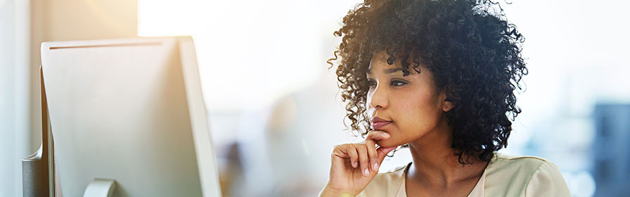 Woman looking at desktop computer screen