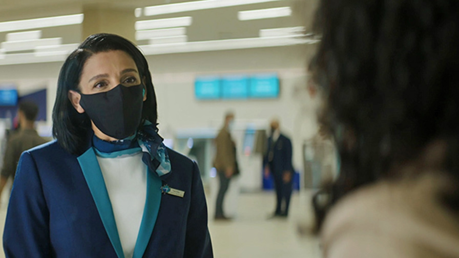 WestJet customer service agent wearing a mask