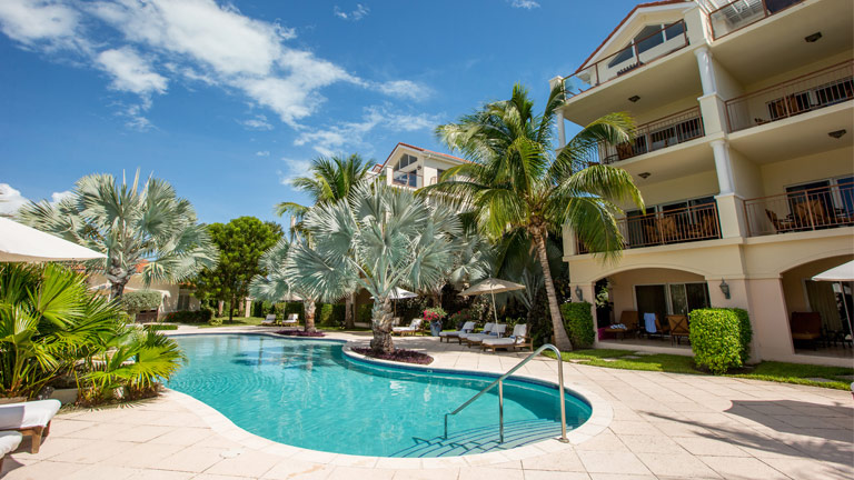 Hotel and palm trees surrounding pool at Villa del Mar Condo