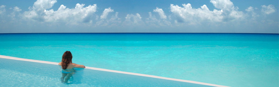 Woman in pool overlooking ocean in Barbados