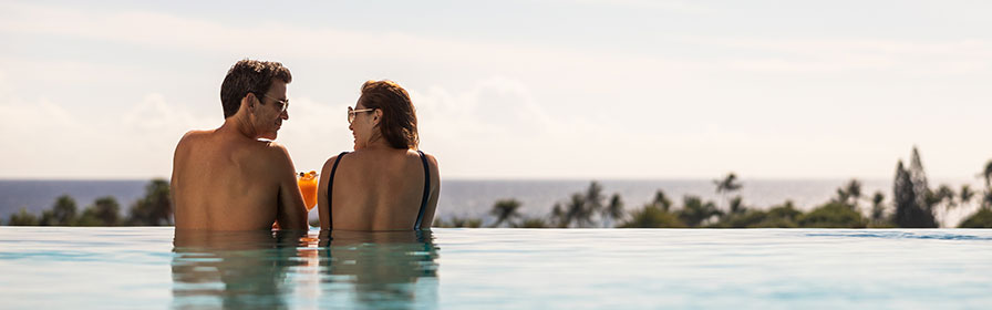 Couple relaxing in the infinity pool