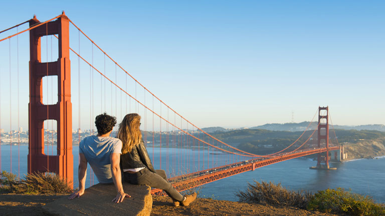 Couple overlooking the Golden Gate bridge in San Francisco