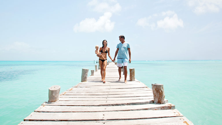 Family walking on dock in the Caribbean