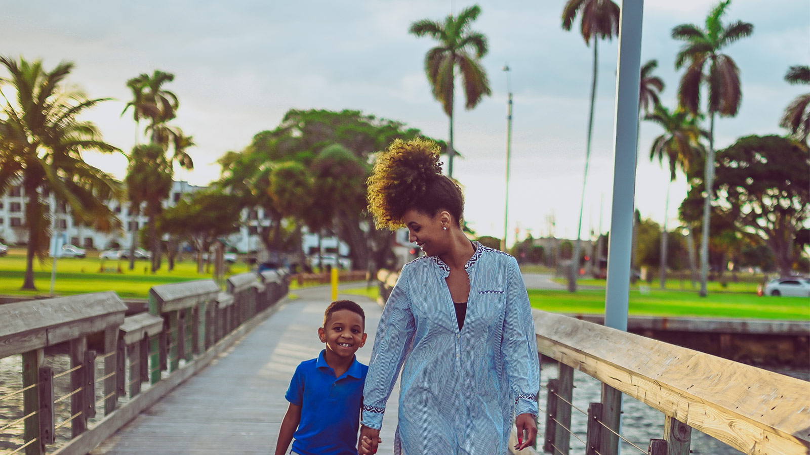 Mother and son walking along pier in Florida