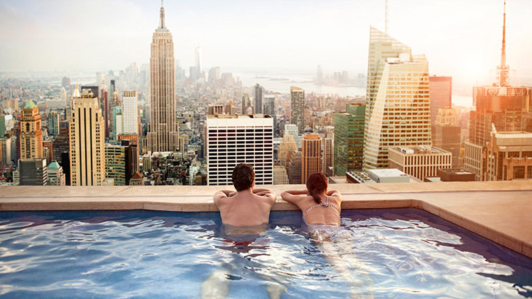 Couple in pool overlooking New York City