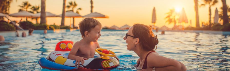 Family playing in pool on all-inclusive vacation