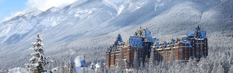 View of Fairmont Banff Springs surrounded by snow-covered mountains