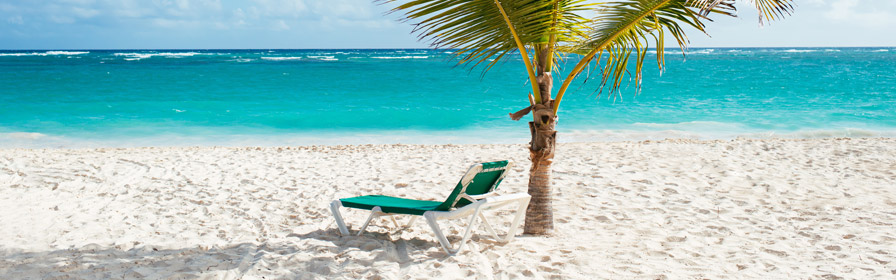 Lounge chair on white sand beach