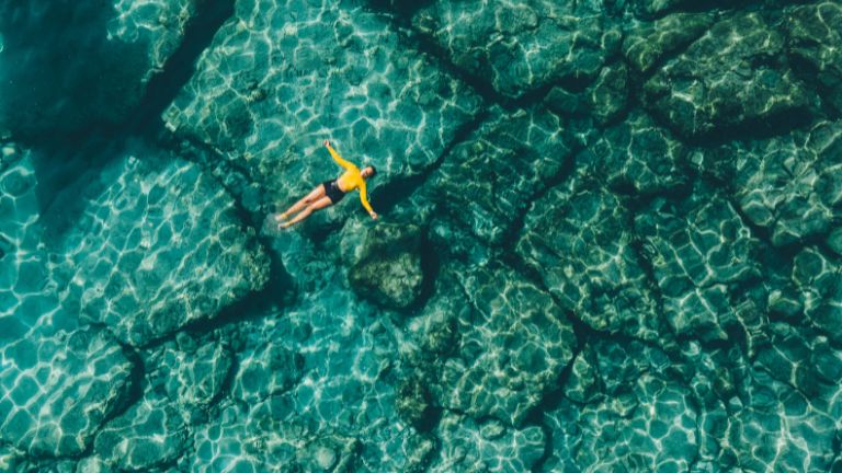 A person floating in the Caribbean sea