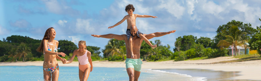 Family walking on beach at all-inclusive Royalton Resort